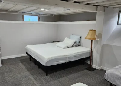 The downstairs bedroom has a queen bed and two twin beds.